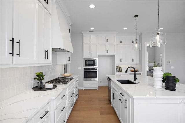 8017 Round Prairie St, Shawnee, KS 66220 - kitchen featuring appliances with stainless steel finishes, custom range hood, recessed lighting, white cabinetry, and backsplash