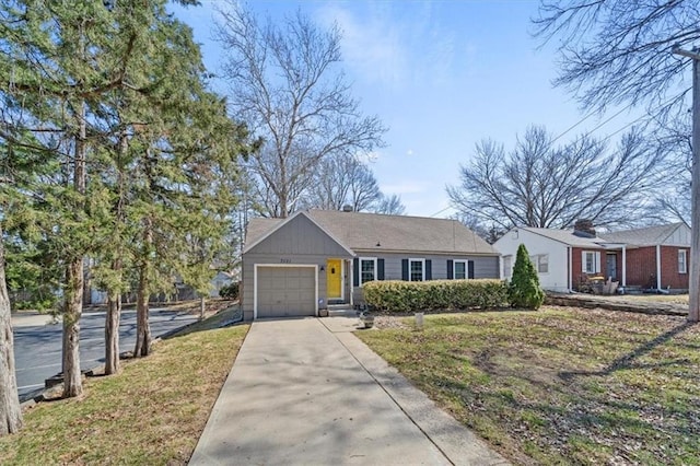 ranch-style home featuring a front lawn, an attached garage, and driveway