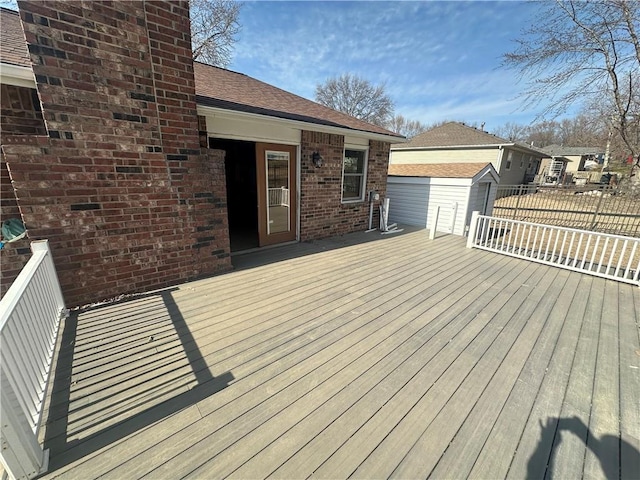 wooden terrace featuring an outbuilding