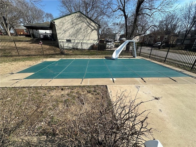 view of swimming pool featuring fence