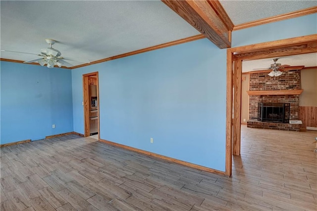 unfurnished living room with a textured ceiling, ceiling fan, and wood finished floors