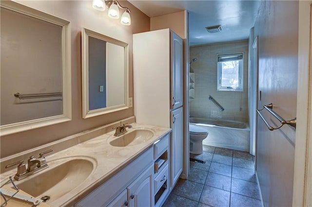 full bathroom with double vanity, visible vents, toilet, and a sink