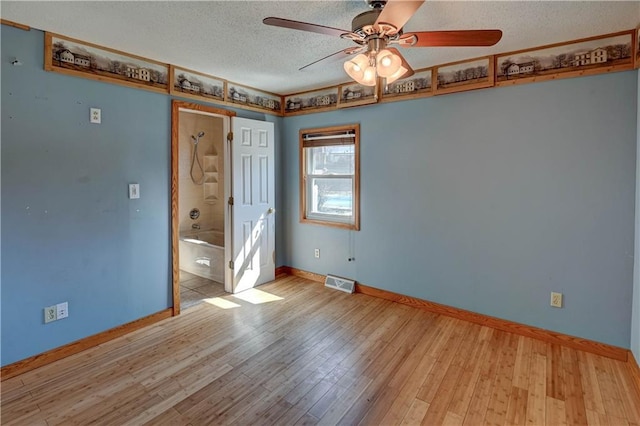 unfurnished bedroom with baseboards, visible vents, light wood finished floors, ceiling fan, and a textured ceiling