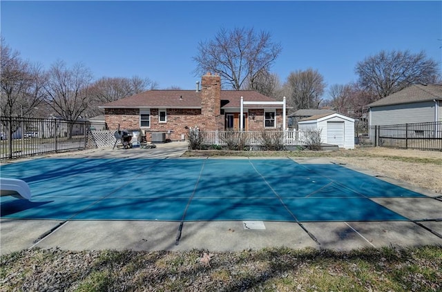 view of swimming pool with central air condition unit, a fenced in pool, and fence