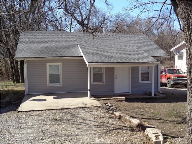 ranch-style house featuring roof with shingles