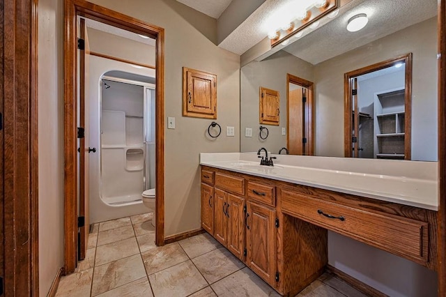 full bath featuring baseboards, toilet, tile patterned floors, vanity, and a shower