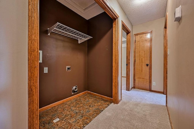 clothes washing area featuring electric dryer hookup, baseboards, a textured ceiling, and carpet flooring