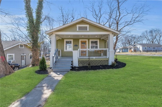 view of front of property with covered porch and a front lawn