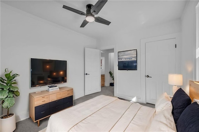 bedroom featuring a ceiling fan, baseboards, and light carpet