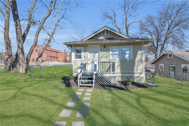 bungalow-style house with a front lawn and fence