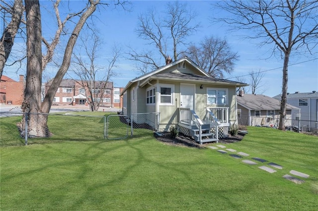 view of front of home with a front yard, a gate, and fence