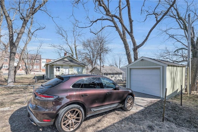 exterior space featuring an outbuilding, driveway, and a detached garage