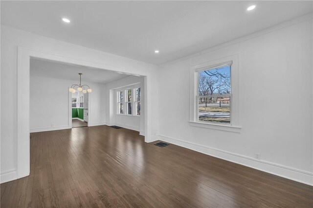 unfurnished living room with recessed lighting, visible vents, baseboards, and dark wood-style flooring