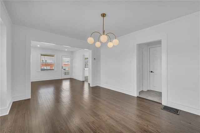 interior space with visible vents, baseboards, a notable chandelier, and wood finished floors