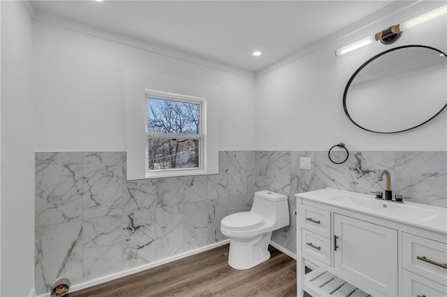 bathroom with vanity, wood finished floors, recessed lighting, tile walls, and toilet