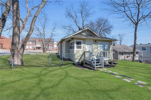 1901 E 79th St, Kansas City, MO 64132 - view of front facade featuring fence, a front yard, and a gate