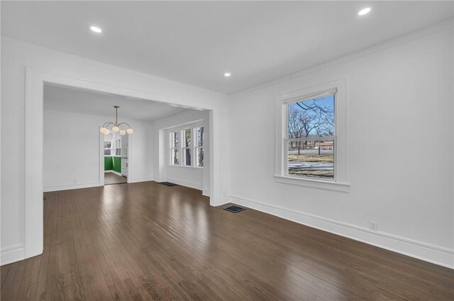 1901 E 79th St, Kansas City, MO 64132 - unfurnished room with visible vents, dark wood-type flooring, a notable chandelier, recessed lighting, and baseboards