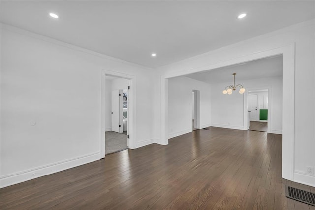 1901 E 79th St, Kansas City, MO 64132 - unfurnished room with dark wood-style floors, recessed lighting, and an inviting chandelier