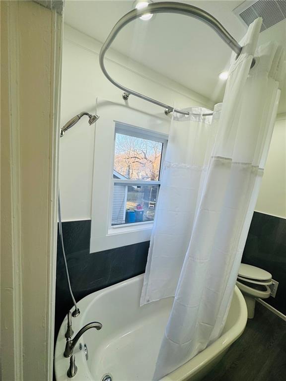 1901 E 79th St, Kansas City, MO 64132 - full bath featuring toilet, shower / bath combo, and visible vents