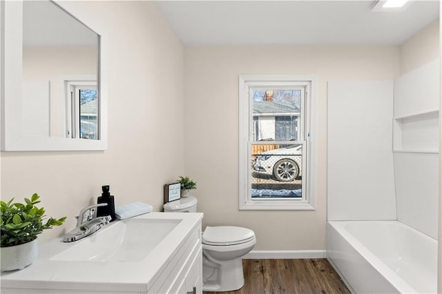 full bath with baseboards, toilet, wood finished floors, and vanity