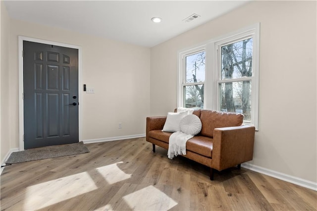 sitting room with visible vents, recessed lighting, light wood-type flooring, and baseboards