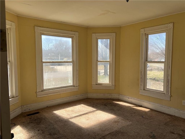 carpeted empty room with visible vents