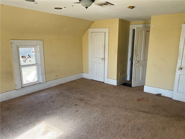 bonus room with visible vents, carpet flooring, and vaulted ceiling