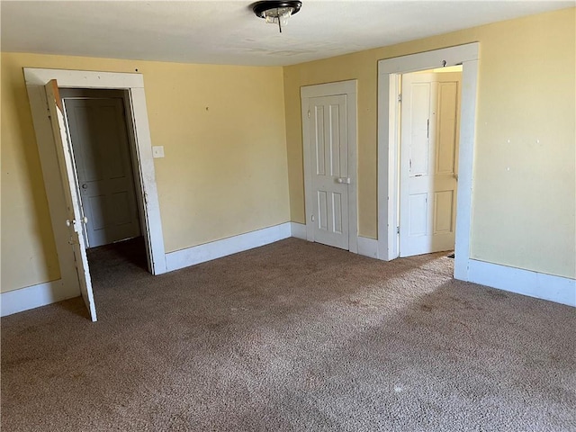 unfurnished room with baseboards and carpet floors