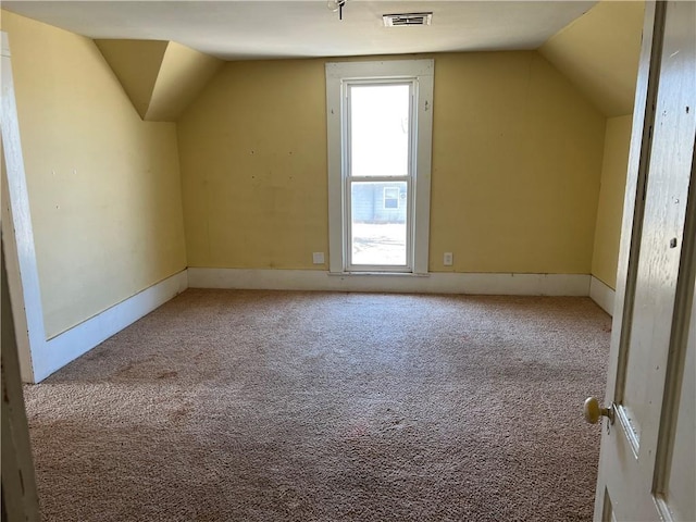 bonus room featuring visible vents, lofted ceiling, and carpet