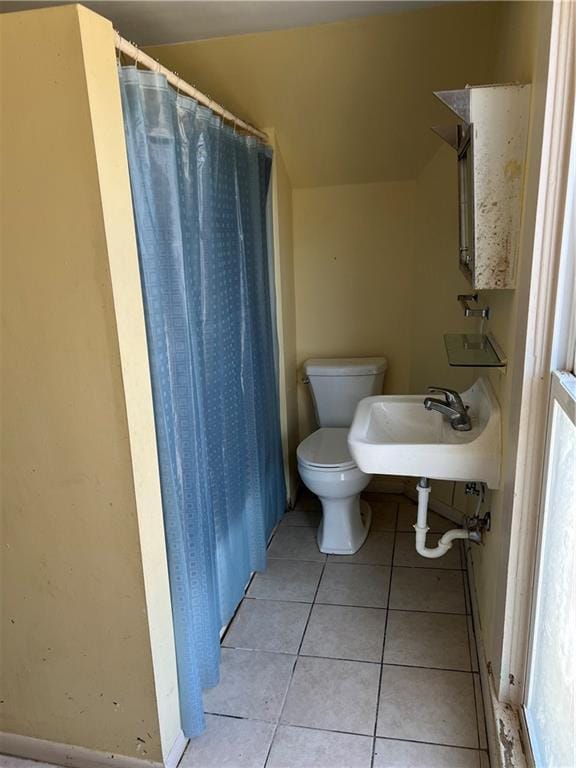 full bathroom with tile patterned floors, toilet, and a sink