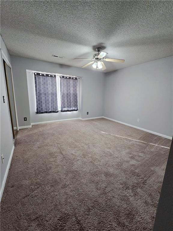 unfurnished bedroom with visible vents, baseboards, ceiling fan, and carpet flooring