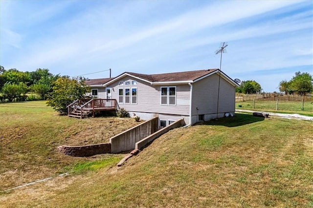 rear view of property featuring a deck