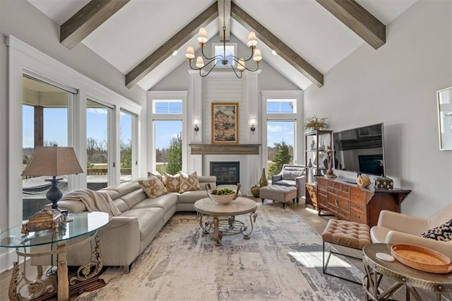 living room with beamed ceiling, a fireplace, high vaulted ceiling, and an inviting chandelier