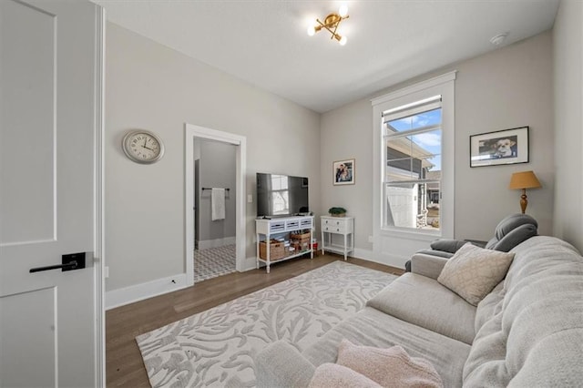 living area with wood finished floors and baseboards