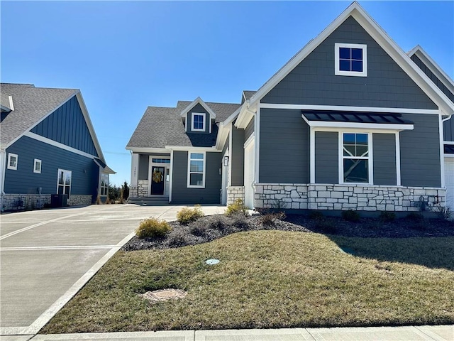 view of front of home with a front yard and stone siding