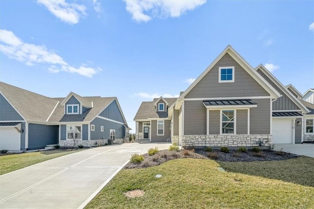 craftsman inspired home with stone siding, board and batten siding, driveway, and a front lawn