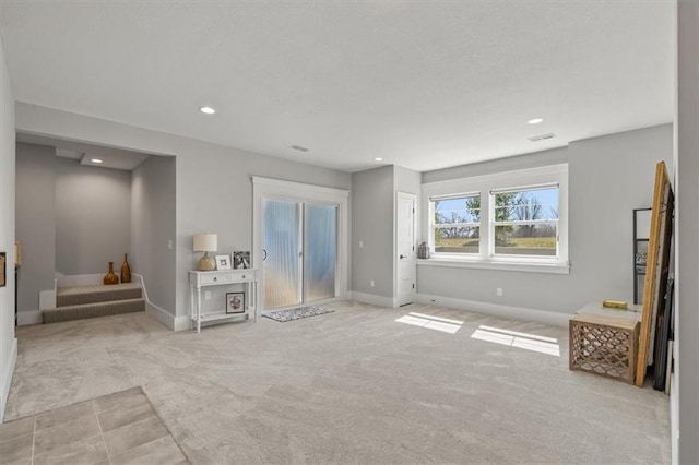 unfurnished living room featuring recessed lighting, visible vents, carpet floors, and baseboards