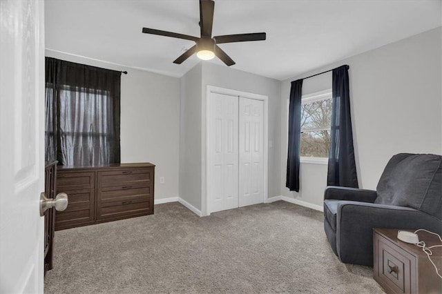 living area with baseboards, a ceiling fan, and carpet flooring