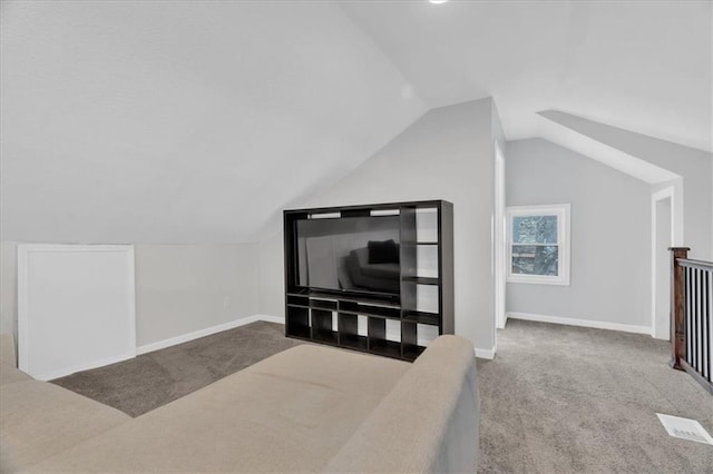 additional living space with baseboards, carpet floors, and lofted ceiling