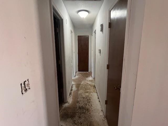 hallway featuring unfinished concrete flooring