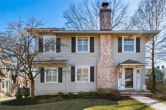 colonial-style house with a chimney