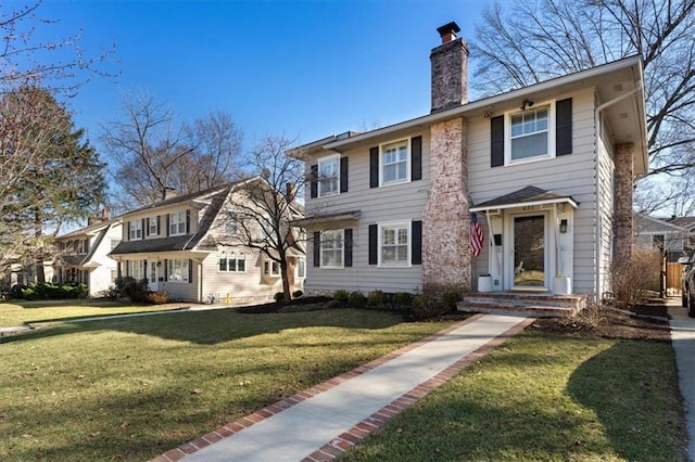 view of front of property with a front lawn and a chimney