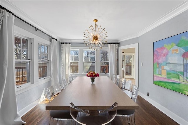 dining room featuring a notable chandelier, wood finished floors, baseboards, and ornamental molding