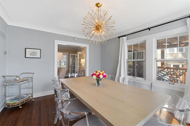 dining room with a chandelier, dark wood-style floors, crown molding, and baseboards