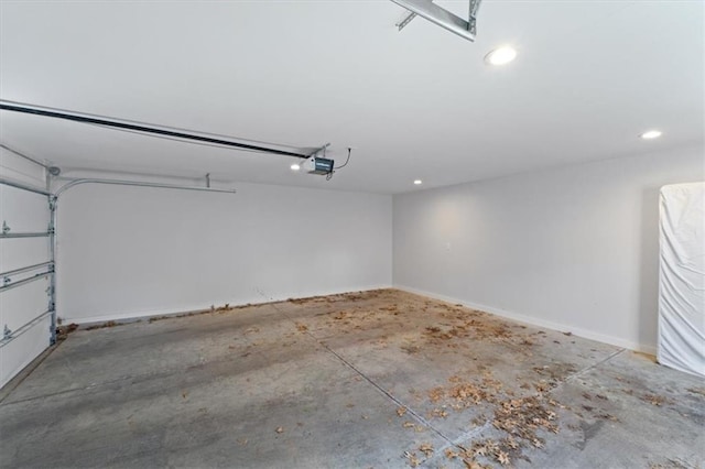 garage with recessed lighting and a garage door opener