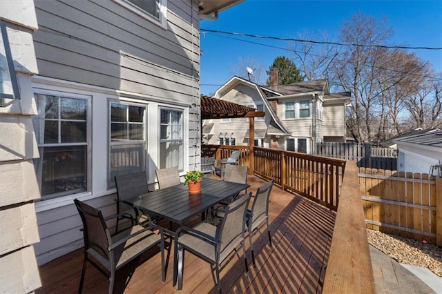 wooden deck featuring outdoor dining area and fence