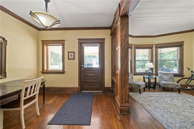 entrance foyer featuring dark wood finished floors, baseboards, and ornamental molding