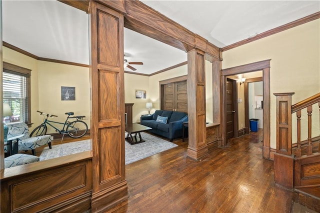 corridor featuring stairway, crown molding, dark wood-type flooring, and decorative columns