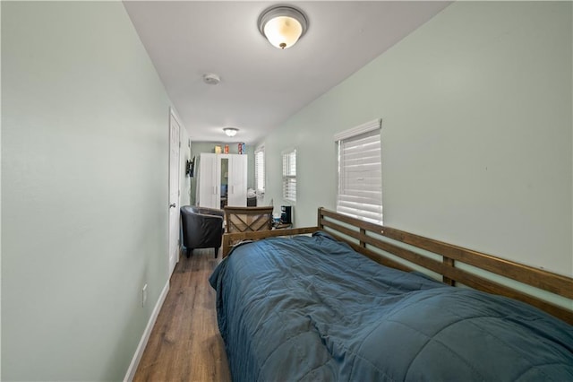 bedroom featuring baseboards and wood finished floors