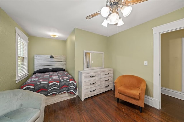 bedroom with baseboards, wood finished floors, and a ceiling fan